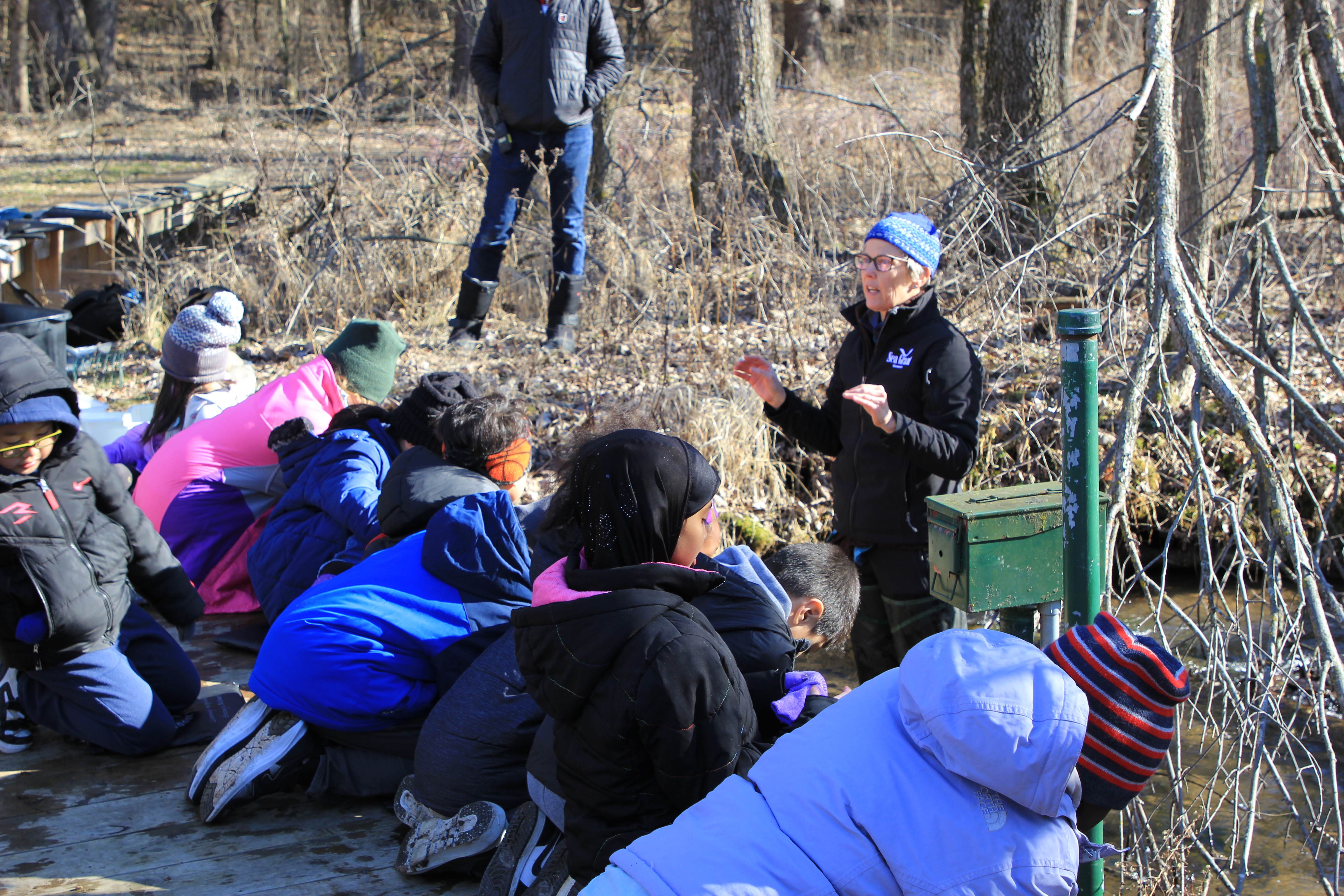 Extension educator Amy Schrank speaks to elementary school students on a winter field trip.