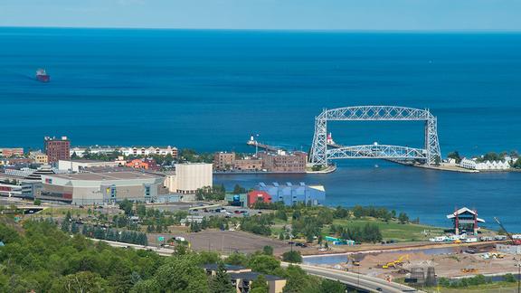 Duluth aerial lift bridge, a ship, sail boats, summer day.