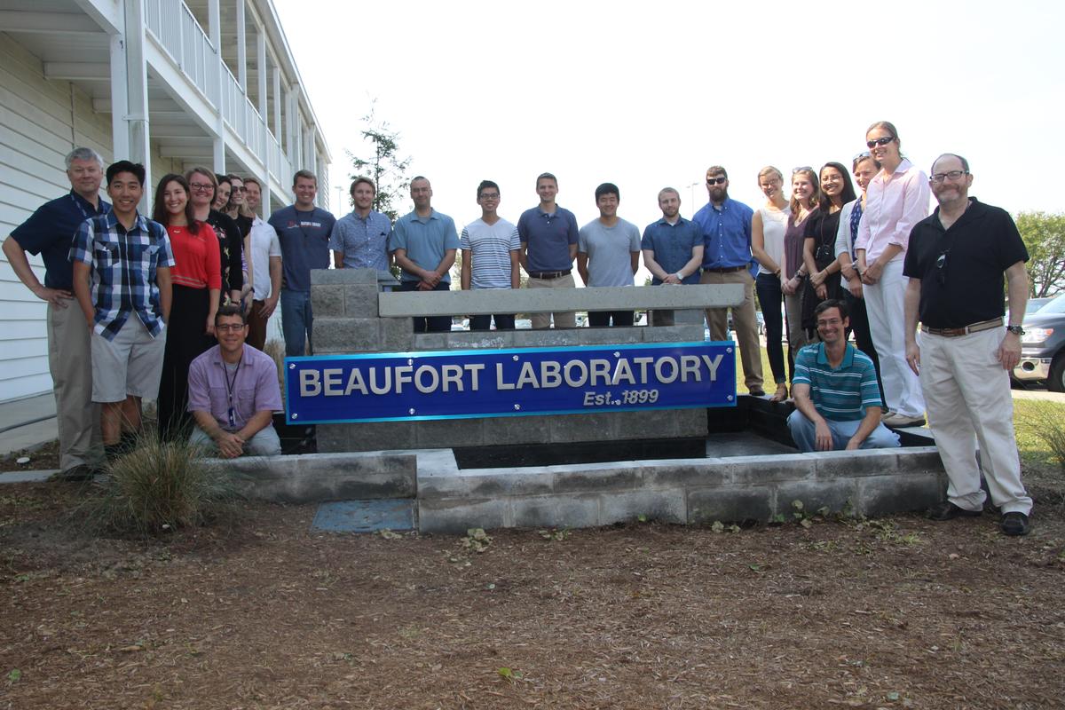 Group of students posting by sign that reads Beaufort Laboratory est. 1899.