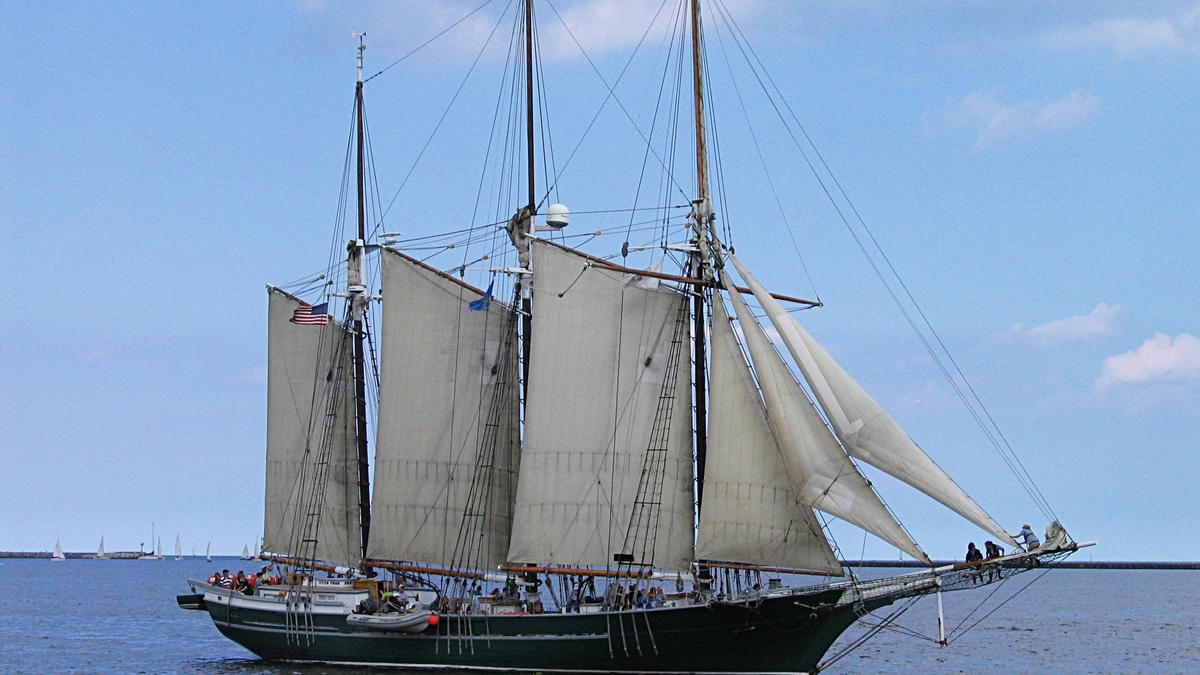 Sailing vessel Denis Sullivan on the waters of a Great Lake is a replica three-masted, wooden, gaff rigged schooner from Milwaukee, Wisconsin.