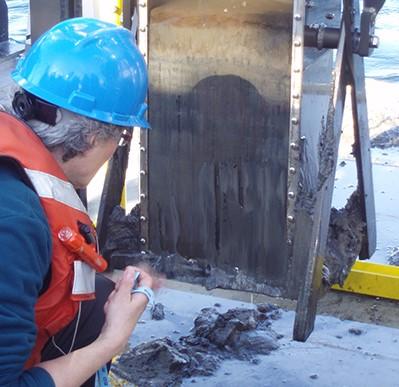 Photo of Kathleen ("Kitty") Kennedy sampling a sediment core on-board the R/V Lake Guardian, Lake Ontario, 2013.