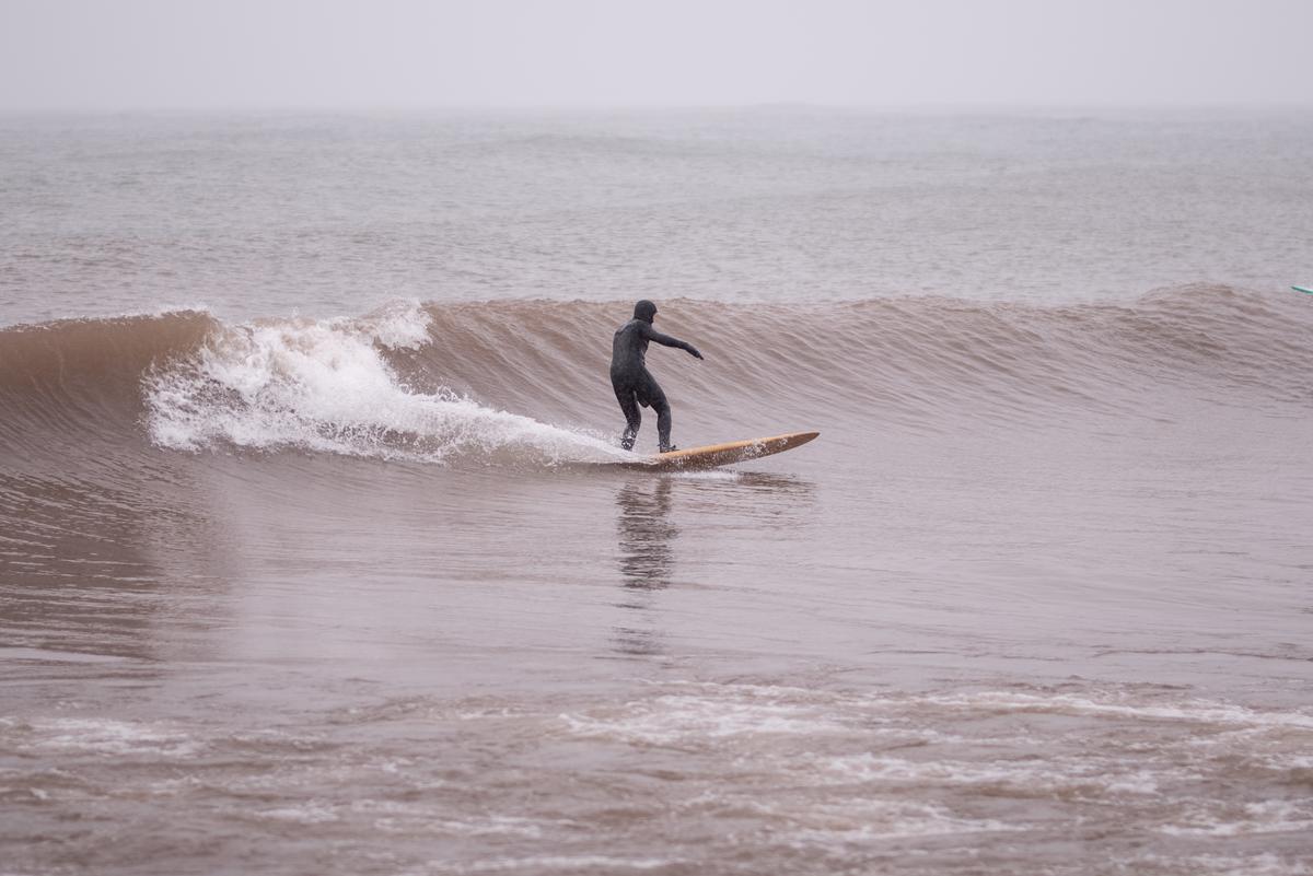 Person surfing Lake Superior during a winter storm.