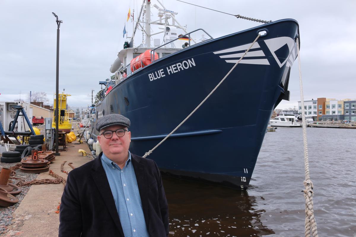 Robert Sterner standing in front of the Blue Heron Research Vessel.