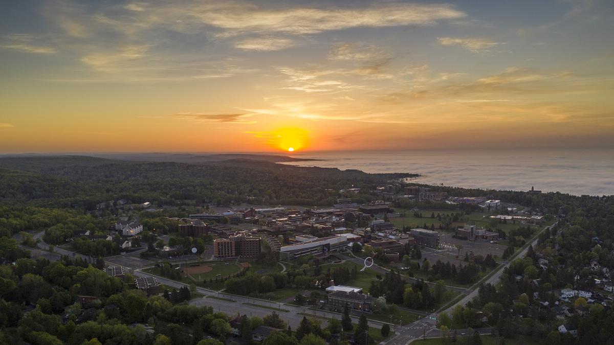 Sunrise over Lake Superior with University of Minnesota Duluth campus in the foreground.