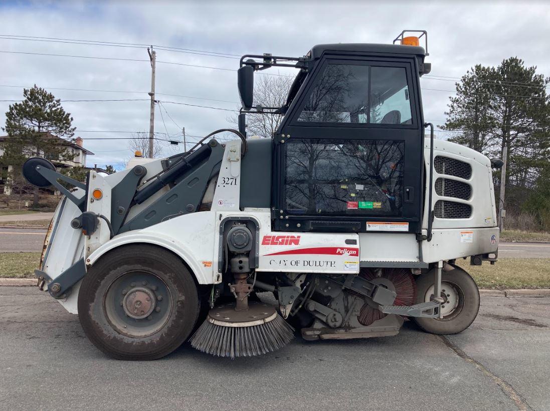 Side profile of a City of Duluth street sweeping vehicle.