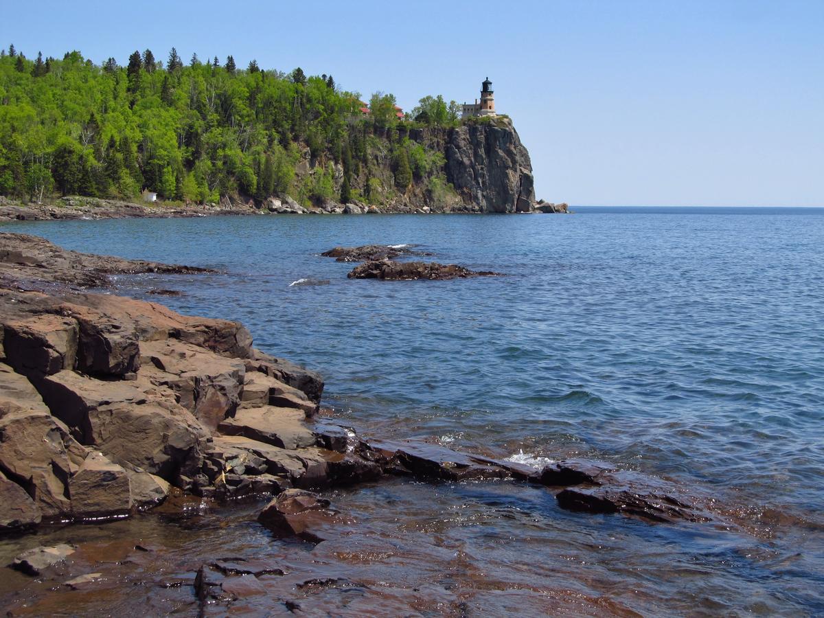 Split Rock Lighthouse on a forested, rocky outcropping overlooking Lake Superior.