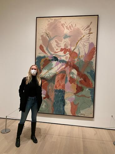 Mary Collins stands next to a Helen Frankenthaler painting at the National Gallery of Art in Washington, D.C.